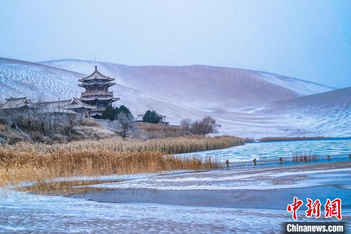 2021年11月28日，雪落鳴沙山月牙泉景區(qū)?！⊥醣筱y 攝