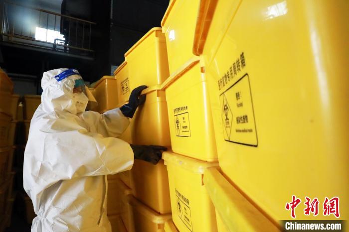 圖為工作人員搬運(yùn)醫(yī)療廢物專(zhuān)用周轉(zhuǎn)箱。　魏建軍 攝