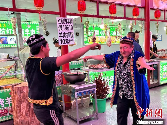 圖為餐飲經(jīng)營(yíng)者在“西涼不夜城”跳起舞蹈引客?！〈魑牟?攝</p><p>